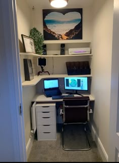 a home office with two computer screens on the desk