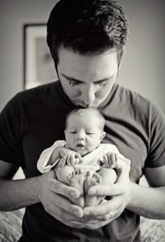 a man holding a baby in his arms