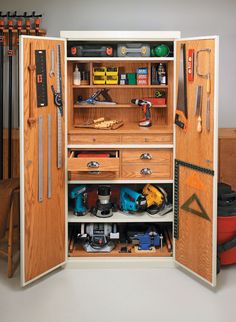 an open cabinet with many tools in it