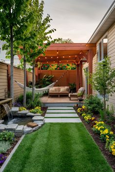 Backyard with a pergola, hammock, outdoor seating, string lights, garden bed, and stone pathway. Townhouse With Backyard, Pergola In Small Backyard, Narrow Garden Landscaping, Extra Small Backyard Ideas, Small Backyard With Pergola, Small Backyard Spaces Ideas, Backyard With Shed Layout, Small California Backyard, Small Backyard Turf Ideas