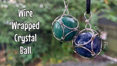 two wire wrapped crystal balls hanging from a black cord with the words wire wrapped crystal ball on it