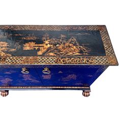 an ornately decorated blue chest with gold trimmings on the top and sides