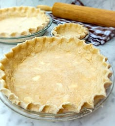 two pie crusts sitting on top of a table