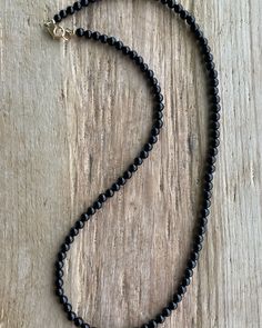 Black Onyx Necklace: Classic Beauty, Made Your Way! https://kathybankston.com/products/black-onyx-necklace-with-sterling-silver-clasp-4mm #blackonyxjewelry #blackonyxnecklace #jewelry #necklace #handmadejewelry #shopsmall #timelessjewelry #classicjewelry #texasmakers Classic Beaded Necklaces With Round Beads For Everyday, Classic Beaded Necklaces With Round Beads, Black Minimalist Necklace With Gemstone Beads, Single Strand Necklaces With Round Beads For Layering, Black Onyx Necklace With Gemstone Beads, Black Single Strand Necklace For Gift, Classic Single Strand Beaded Necklaces, Minimalist Black Gemstone Beads Necklace, Classic Single Strand Beaded Necklace For Everyday