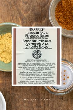 the ingredients for starbucks pumpkin spice are shown in bowls on a wooden table with a sign that reads starbucks pumpkin spice