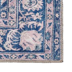 a blue and pink rug with an elephant design on the middle, surrounded by flowers