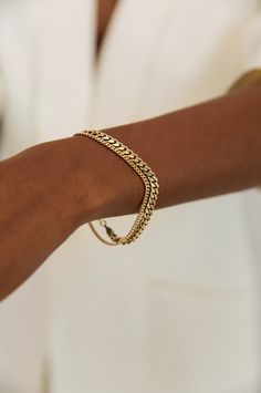 The Capri Curb Chain Collection is an absolute timeless classic — then, now, always. Elevated with subtle detail in the chain, each bracelet is made from a long chain, so each piece is one of a kind. This bracelet is available with or without the single floating 0.1cw diamond set in the chain. Layer up with our Familia Cuban Bracelet. 14k solid gold - always Weighs about 5 grams Chain is approximately 2.5mm thick Diamond Clarity: SI 1-2 We offer custom sizes upon request. Please add the Custom S Classic Cuban Link Bracelets For Everyday, Classic Cuban Link Bracelet For Everyday, Classic Link Chain Tennis Bracelet, Classic Chain Tennis Bracelet, Classic Cuban Link Chain Bracelet, Everyday Gold Cuban Link Bracelet, Classic Cuban Link Bracelet With Curb Chain For Everyday, Classic Curb Chain Bracelet, Classic Cuban Link Bracelet With Oval Links