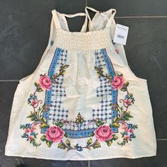 Free People Sleeveless Top With Embroidered Floral Design. New With Tags. Cream Floral Embroidered Summer Tops, Spring White Tank Top With Floral Embroidery, White Floral Embroidery Tank Top For Spring, Summer Embroidered Cotton Tank Top, Summer Cotton Embroidered Tank Top, White Embroidered Tank Top For Spring, Embroidered Off White Summer Tops, Off White Embroidered Summer Tops, White Embroidered Cami Tank Top