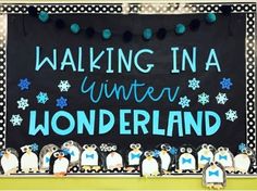 a sign that says walking in a winter wonderland with penguins and snowflakes on it