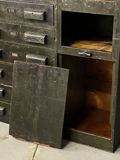 an old metal filing cabinet sitting on the sidewalk