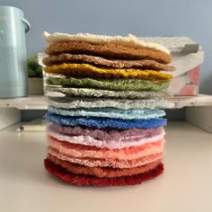 a stack of towels sitting on top of a white table next to an air humider