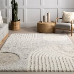 a living room with white walls and rugs