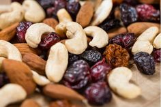 nuts and raisins are mixed together on a cutting board