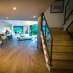 a living room filled with furniture next to a staircase