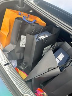 there are many bags in the trunk of this car, which is full of items