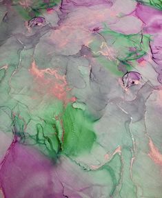 an abstract painting with purple, green and pink colors on the surface that looks like marble