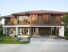 a large house with lots of windows and wooden shutters on the front door is shown