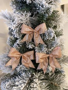 three bows on the top of a christmas tree