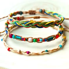 three different colored bracelets on top of each other