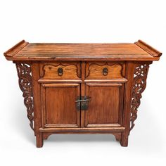 an old wooden cabinet with two doors and carvings on the front, sitting against a white background