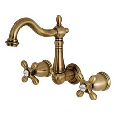 an antique brass faucet with three white flowers on the side and two handles