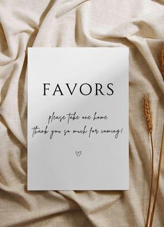 a piece of paper that says favors on it next to some dried flowers and a card