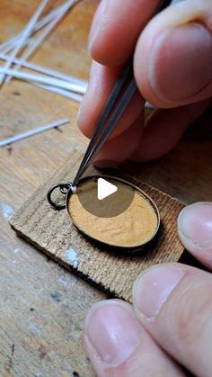 a person is using scissors to cut a piece of wood