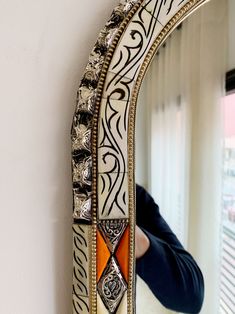 a woman taking a selfie in front of a mirror with the reflection of her