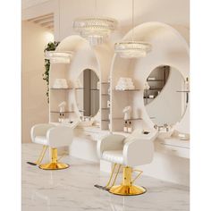 two white chairs with gold legs in front of mirrors and chandeliers on the wall