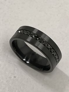 a black ring with white diamonds on it