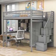 a loft bed with desk underneath it and stairs to the upper level, in a room with hardwood floors