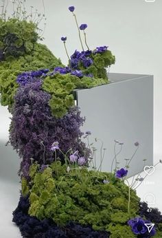 an artistic sculpture made out of moss and flowers