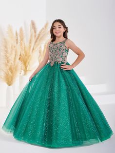 Your sweet girl will love twirling around in this sequin applique long sleeveless dress with A-line shimmer tulle skirt by Tiffany Princess 13690. Scoop neck sleeveless with fully sequined lace applique bodice, shimmer glitter tulle ballgown skirt, and a lace-up back. House of Wu Tiffany Princess Collection Fall 2022 Style Number: 13690 Fabric: Sequin Lace Appliques/Shimmer Tulle Please note: There may be a loss of glitter while wearing this dress due to the nature of the fabric Colors: Emerald Tulle Ballgown, Long Sleeveless Dress, Ballgown Skirt, African Attire Dresses, Girls Applique, 2022 Style, Girls Formal Dresses, Sequin Appliques, Ball Gown Skirt