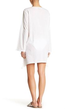 Casual yet chic, this cover up dress is the perfect mate for your bikini. Embellished with beautiful embroidery , the throw on and ready to go style is comfortable and easy to wear. This tunic-style v-neck dress is a must have from the house of La Moda. • Dress, Cover Up • Beachwear, Resort Wear • 100% Rayon • Goga Swimwear • Available in White • Size: S/M, L/XL • Washing Instruction: Hand Wash with Cold Water, Tumble Dry, Do not Iron Spring V-neck Beachwear Tunic, White V-neck Loungewear Cover-up, Summer V-neck Tunic For Vacation, White V-neck Cover-up For Loungewear, Unlined V-neck Cover-up For Vacation, Spring Cotton Tunic Cover-up, Summer Tunic Cover-up, Summer Beachwear Tunic For Beach Cover-up, Chic V-neck Festival Cover-up