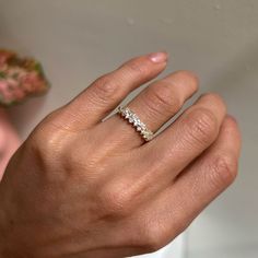 a woman's hand with a diamond ring on it