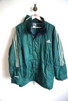 Jacket details: * Green ADIDAS windbreaker outwear jacket * Zipper and snap buttons on front * Two pockets * Condition: Perfect vintage condition, but zipper is broken, thats why price reduced.  Length: 37 " / 86cm Armpit to armpit: 28" / 68 cm sleeve: 25" / 62cm Label size: D-7 (L) Feel free to message me with any questions Adidas Track Jacket For Training, Adidas Sportswear Track Jacket For Training, Athleisure Nylon Track Jacket With Three Stripes Branding, Athleisure Nylon Track Jacket With Three Stripes, Nylon Athleisure Track Jacket With Three Stripes, Sporty Nylon Outerwear With Three Stripes, Sporty Nylon Outerwear With Stripes, Sporty Adidas Windbreaker For Winter, Sports Nylon Outerwear With Three Stripes Branding