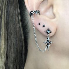 LISTING FOR 1 PIECE ONLY Gothic inspired Cross earring is attached with a chain to the Ear cuff.  Cuff part of the earring needs no piercing, just slide on the ear. This cuff fits both right and left ears.  Material:316 Stainless steel/ set with Black Cubic Zirconia stones Total earring length"  3 1/2"  Cuff :5.5 mm Cross stud:  25 mm *RETURNS / REFUNDS * -If you would like to return you purchase , please contact us within 7 days of receiving your package and we will accept the return.Return will only be made to the product, and not the shipping cost.  -Buyer is  responsible for the return shipping costs . -All jewelry must be returned unworn and in their original condition . *LOST MAIL* Once the package is marked as DELIVERED by the post office, we are not responsible for misplaced or sto Gothic Ear Piercings, Goth Earrings Aesthetic, Silver And Black Earrings, Goth Ear Piercings, Gothic Piercings, Ear Piercings Black, Alt Earrings, Mens Earring, Dark Earrings