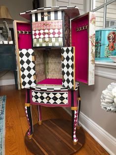 a pink and black chair with lots of drawers on top of it's sides