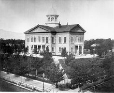 an old photo of a large building with a clock tower on it's roof