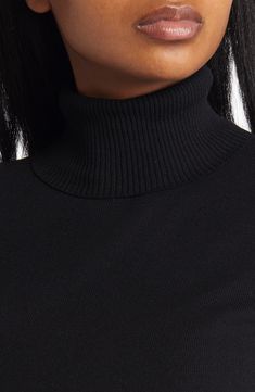 Elbow-length sleeves make this lightweight turtleneck sweater perfect for those in-between weather days. Turtleneck Elbow-length sleeves 65% rayon, 35% nylon Dry clean Imported Stretch Black Turtleneck, Fall Turtleneck With Ribbed Neckline, Black High Neck Turtleneck With Ribbed Collar, Black High Neck Ribbed Turtleneck, Fall Black Turtleneck With Ribbed Neckline, Black Stretch Turtleneck In Fine Knit, Black Stretch Fine Knit Turtleneck, Fall Turtleneck With Ribbed Funnel Neck, Fall Turtleneck With Funnel Neck And Ribbed Neckline