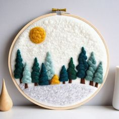 an embroidery project with trees and sun in the background