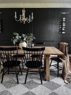 a dining room table with chairs and a chandelier