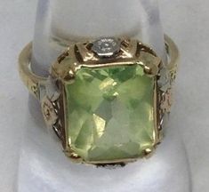 For sale is a Lovely 10K Yellow Gold Filigree Synthetic Spinel Ring. Size 7. Stamped 10K. This Ring contains one 5.80 carat Synthetic Yellow/green Spinel (though I believe it is more Green than Yellow.) Total weight is 4.2 grams. This lovely ring comes with a GIA Appraisal for almost $700. (appraisal is included with your purchase.) it is a modified Emerald/radiant cut and it is simply lovely. It is a size 7 and is easily sizable by your local jeweler. If you have any additional questions, pleas Antique Green 14k Stamped Jewelry, Antique Green Jewelry Stamped 14k, Vintage Green Filigree Ring With Gemstone, Victorian 14k Stamped Green Jewelry, Victorian Green Jewelry Stamped 14k, Antique Green Filigree Rings, Green Heirloom Filigree Ring For Formal Occasions, Heirloom Green Filigree Ring For Formal Occasions, Spinel Ring