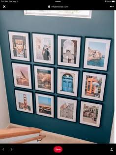 a blue wall with pictures on it and some stairs in front of the photo frame