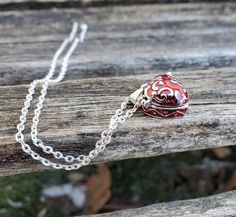 This heart locket necklace is perfect for anyone! It is silver with red enamel and a scrolling silver design on the top. It has a little hook on one side and it can be opened up and you can put whatever you want inside. It's about 4 mm deep inside x 14mm wide. These would be great for any time of the year! This is a wonderful gift for a wedding, bride or bridesmaid gift, for a Christmas gift, for Mother's Day, or a birthday. This listing is for one chain and pendant. Red Heart Charm Necklace For Anniversary Gift, Heart Necklace With Lobster Clasp As Gift, Red Heart Pendant Charm Necklace For Gifting, Red Necklace With Heart Charm For Anniversary Gift, Silver Heart Charm Necklace As Gift, Valentine's Day Gift Locket Necklace With Round Pendant, Red Heart Pendant Charm Necklace As Gift, Red Necklace With Heart Charm For Anniversary, Red Double Heart Necklace For Gift