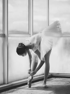 black and white photograph of a ballerina bending over