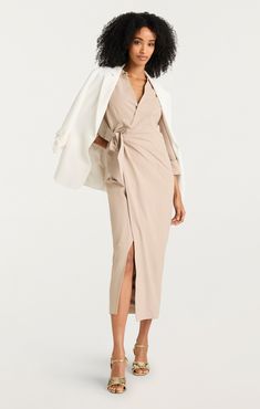 Experience effortless transitions from desk to dinner with the versatile Cayleigh Dress. Its collared neckline, wrap silhouette, and tie detail lend versatility and elegance, while a modesty clasp ensures a sleek look for work. With cuffed sleeves and a midi length, this khaki dress will keep you confident and comfortable all day long. Don't miss out on this must-have piece. Details Hidden zipper on sideFabric: Sadie StretchMidi Twist detail Long sleeve Content and Care 93% Polyester 7% PolyurethaneDry CleanImported Measurements 50in/127cm from shoulderMeasurements from size 4 Short Denim Skirt, Evening Tops, Denim Outerwear, Khaki Dress, Tank Top Camisole, Work Looks, Knitted Tank Top, Sleek Look, Knit Tanks