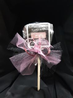 a candy lollipop on a stick with a pink bow around it's edge