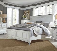 a bedroom with gray walls and white furniture