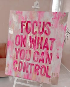 a pink sign with the words focus on what you can't control written on it